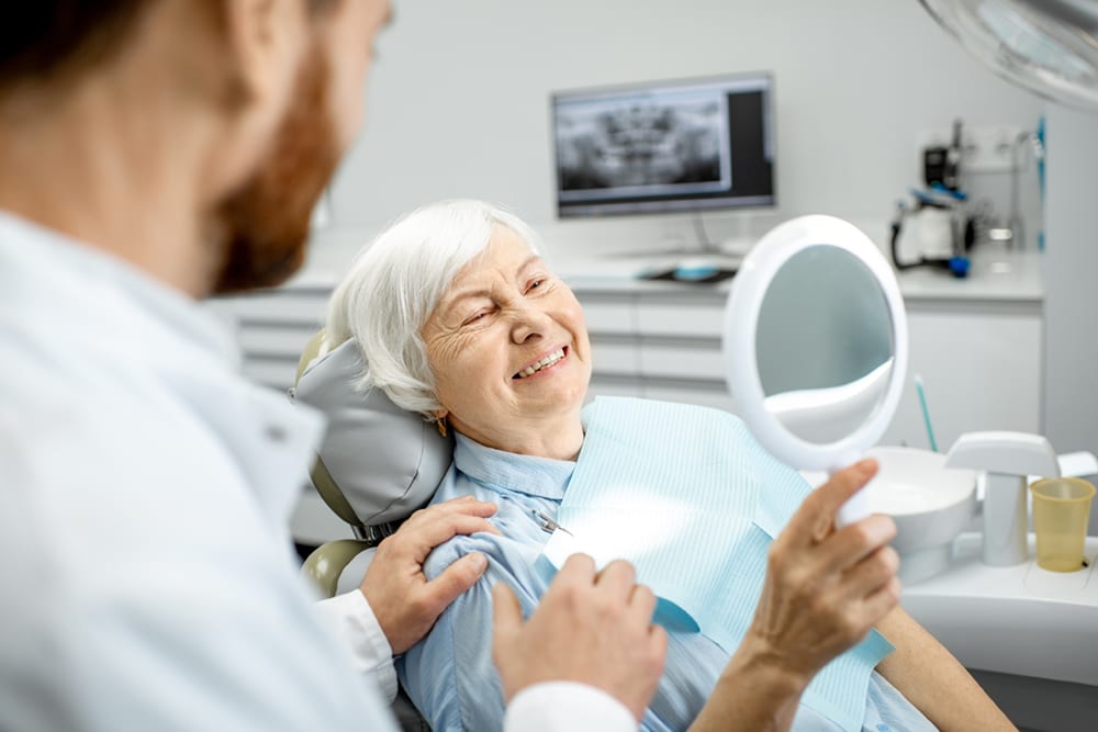Older woman at the dentist for a dental implants consultation
