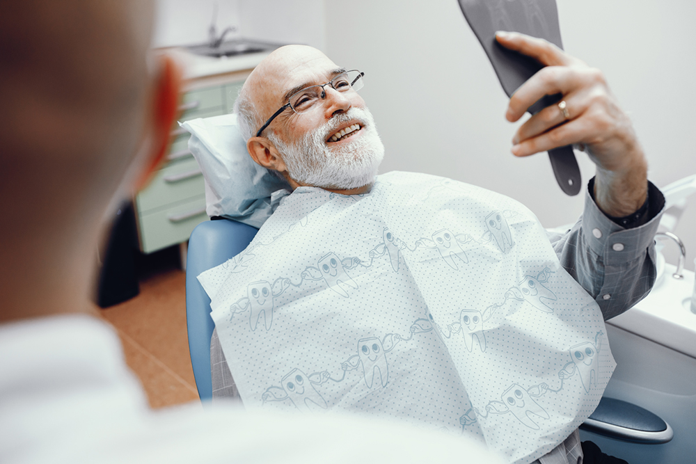 Man in a dental chair after Prosthetic Rehabilitation